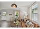 Open living space with a brown leather sofa and a small dining table near the entryway at 209 W Emma St, Tampa, FL 33603