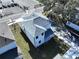 A high angle shot showing the home's layout, its well-maintained roof, and verdant lawn at 2404 1/2 E Chelsea, Tampa, FL 33610