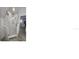 A bathroom with a glass shower, grey tile floor, and views into the kitchen at 2404 1/2 E Chelsea, Tampa, FL 33610