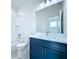 Well-lit bathroom with a combination tub and shower, dark blue vanity, and modern fixtures at 2404 1/2 E Chelsea, Tampa, FL 33610