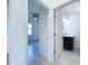 View through doorway to bedroom with ceiling fan and to bathroom with black cabinets at 2404 1/2 E Chelsea, Tampa, FL 33610