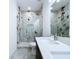 Modern bathroom featuring a large, glass-enclosed shower with marble tiling and a double sink vanity at 2404 1/2 E Chelsea, Tampa, FL 33610
