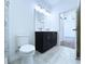 Neutral bathroom showcasing a toilet, vanity with double sinks and walk-in shower at 2404 1/2 E Chelsea, Tampa, FL 33610