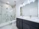 Elegant bathroom featuring a walk-in shower, dual sink vanity, and tile flooring at 2404 1/2 E Chelsea, Tampa, FL 33610