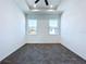 Bright bedroom features neutral walls, a ceiling fan and two windows allowing for natural light at 2404 1/2 E Chelsea, Tampa, FL 33610