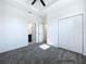 A spacious bedroom featuring a closet, ceiling fan, and neutral carpet at 2404 1/2 E Chelsea, Tampa, FL 33610