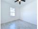 A bright and airy bedroom featuring a ceiling fan and a window with natural light at 2404 1/2 E Chelsea, Tampa, FL 33610
