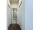 Hallway view featuring a bathroom with a glass door shower and tiled walls at 2404 1/2 E Chelsea, Tampa, FL 33610
