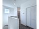 Upstairs hallway featuring a closet with paneled doors and access to rooms in the home at 2404 1/2 E Chelsea, Tampa, FL 33610