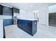 Kitchen with an island with granite countertops, stainless steel fridge, and view of the stairs at 2404 1/2 E Chelsea, Tampa, FL 33610