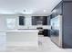 Bright kitchen boasts granite countertops, stainless appliances, black cabinets, and island at 2404 1/2 E Chelsea, Tampa, FL 33610