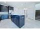 Kitchen with kitchen island, stainless steel fridge and view to the staircase at 2404 1/2 E Chelsea, Tampa, FL 33610