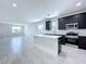 An open concept kitchen with tile floors, an island, stainless steel appliances, and dark cabinets at 2404 1/2 E Chelsea, Tampa, FL 33610