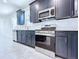 Kitchen features black cabinets, stainless steel appliances, and tile floors at 2404 1/2 E Chelsea, Tampa, FL 33610
