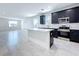 Kitchen features island, stainless steel appliances, white walls, and tile floor at 2404 1/2 E Chelsea, Tampa, FL 33610