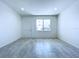Bright and airy living area featuring smooth tile flooring and a window overlooking a pleasant front view at 2404 1/2 E Chelsea, Tampa, FL 33610
