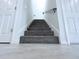 Carpeted staircase featuring tile floors and doors on both sides at 2404 1/2 E Chelsea, Tampa, FL 33610