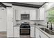 Modern kitchen featuring white cabinets, granite countertops, and stainless steel appliances at 815 St Francis St, Brooksville, FL 34601