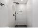 Clean and spacious walk-in shower with hexagon tile flooring and black fixtures at 815 St Francis St, Brooksville, FL 34601