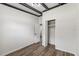 Simple bedroom with wood-look floors and access to another room at 815 St Francis St, Brooksville, FL 34601