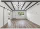 Open living space with exposed beams and barn doors at 815 St Francis St, Brooksville, FL 34601