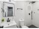 Modern bathroom with white tile, walk-in shower, and black matte fixtures at 815 St Francis St, Brooksville, FL 34601