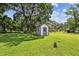 White shed with purple trim in a large backyard at 815 St Francis St, Brooksville, FL 34601