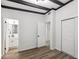 Bright bedroom with wood-look floors, en-suite bathroom access, and ample closet space at 815 St Francis St, Brooksville, FL 34601