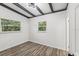 Bright bedroom with wood-look floors and two windows at 815 St Francis St, Brooksville, FL 34601