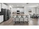 Kitchen island with seating for four and granite countertops at 8861 Forge Breeze Loop, Wesley Chapel, FL 33545
