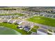Aerial view of a residential area with houses and a lake at 8861 Forge Breeze Loop, Wesley Chapel, FL 33545