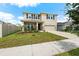 Two-story house with landscaped yard and large driveway at 8861 Forge Breeze Loop, Wesley Chapel, FL 33545