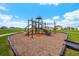 Community playground with a slide, climbing structure, and wood-chip surface at 8861 Forge Breeze Loop, Wesley Chapel, FL 33545