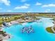 Large lagoon pool with floating playground and water features at 8861 Forge Breeze Loop, Wesley Chapel, FL 33545