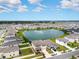 Community with lake, houses, and green spaces at 8861 Forge Breeze Loop, Wesley Chapel, FL 33545