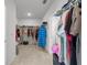 Large walk-in closet with double hanging rods and shelving at 8861 Forge Breeze Loop, Wesley Chapel, FL 33545