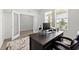 Spacious home office featuring a large desk and window views at 8861 Forge Breeze Loop, Wesley Chapel, FL 33545
