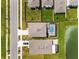 Aerial view showing homes, pools, and a lake at 8861 Forge Breeze Loop, Wesley Chapel, FL 33545