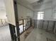 A kitchen undergoing renovation, featuring exposed framing and new tile flooring at 2704 2Nd St # 7, Indian Rocks Beach, FL 33785
