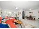 Bright living room with orange sectional sofa and dining area at 2704 2Nd St # 7, Indian Rocks Beach, FL 33785