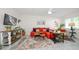 Relaxing living room, orange couch, stylish decor, and large TV at 2704 2Nd St # 7, Indian Rocks Beach, FL 33785