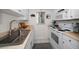 Clean kitchen featuring white cabinets, stove, and microwave at 2704 2Nd St # 7, Indian Rocks Beach, FL 33785