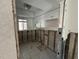 Renovation in progress: a kitchen with exposed framing and new tile flooring at 2704 2Nd St # 7, Indian Rocks Beach, FL 33785