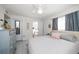 Bright bedroom with a queen-size bed, dresser, and access to a bathroom at 2704 2Nd St # 7, Indian Rocks Beach, FL 33785