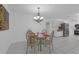 Dining area with glass table, decorative chairs, and ornate chandelier lighting at 8002 Lake Dr, Palmetto, FL 34221