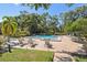 Community pool with lounge chairs and lush landscaping at 1502 Lennox E Rd # 1502, Palm Harbor, FL 34683