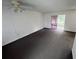 Living room with grey carpeting and access to a screened patio at 12026 Boynton Ln # Gb32, New Port Richey, FL 34654