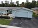 Light blue home with attached garage and neatly landscaped yard at 12026 Boynton Ln # Gb32, New Port Richey, FL 34654