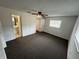 Bedroom with ceiling fan and access to bathroom at 12026 Boynton Ln # Gb32, New Port Richey, FL 34654