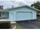 Light blue home with a garage and neatly manicured landscaping at 12026 Boynton Ln # Gb32, New Port Richey, FL 34654